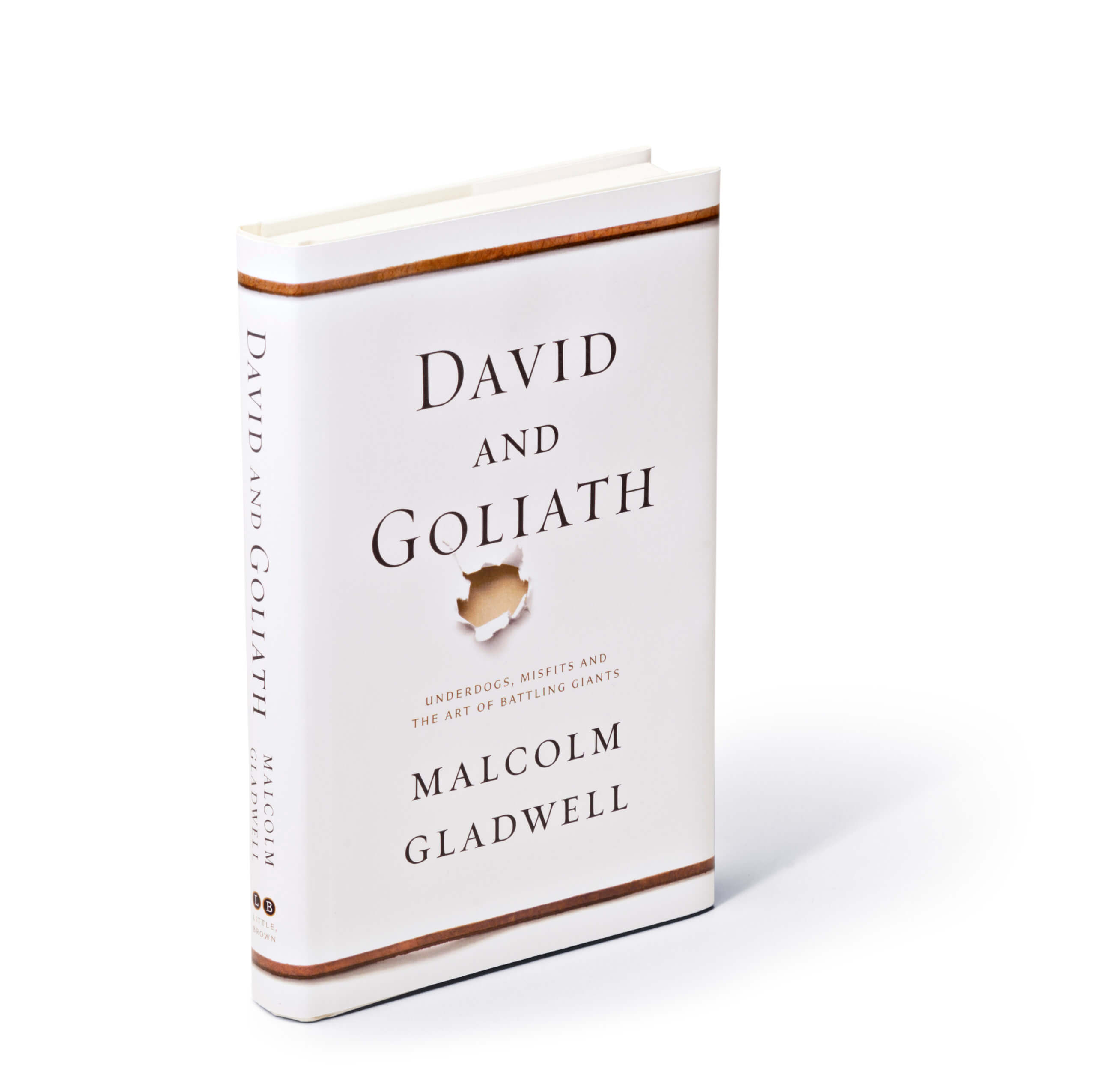 Hole punched through white paper below David and Goliath title on book cover