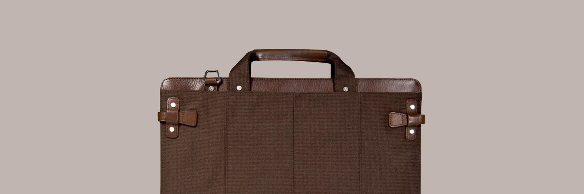 Top portion of brown briefcase on tan-gray background