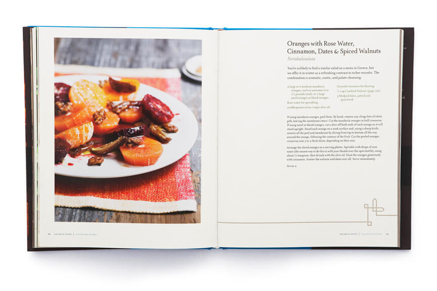 Open cookbook showing plated citrus slices adjacent to page of text