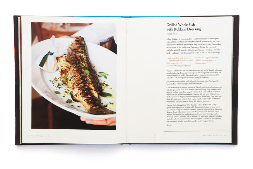 Open cookbook showing plated fish adjacent to page of text