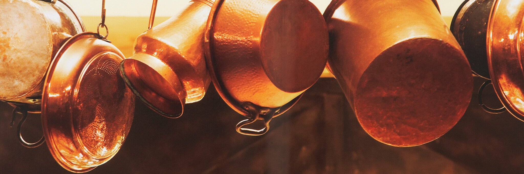 Copper pots and pans hanging from hooks