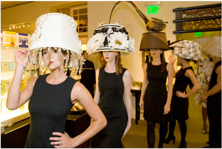 Models in line wearing lampshade headdresses