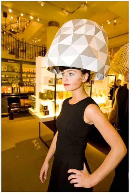 Woman wearing white geometric lampshade headdress