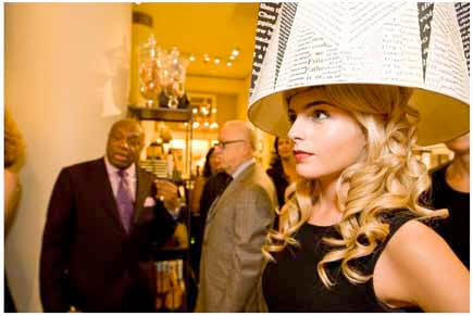 Woman wearing typographic lampshade headdress