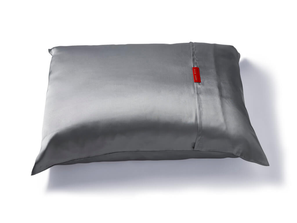 Silver pillow with red tag